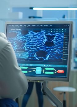 scientist-working-laboratory-analysing-test-trial-vaccine-checking-drug-data-standing-front-pc